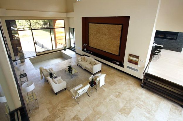 The Mississauga house delivered: staged double-height living room with stone floors